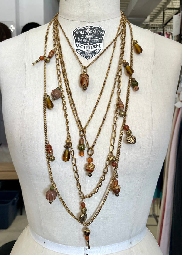 KATE HINES 5 strand gold chain layered necklace w/ brown/orange/green glass beads, 19" long